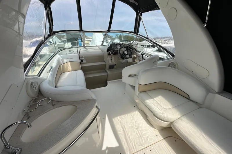 Slide: The Image of 2008 Sea Ray Sundancer 260 interior with plush seating and helm, showcasing luxury design. - 10