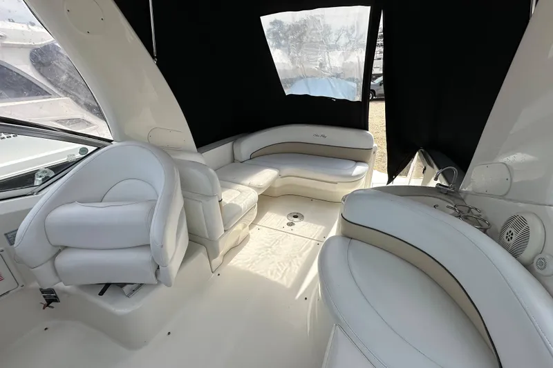 Slide: The Image of Interior of 2008 Sea Ray Sundancer 260 with white leather seating and black curtains. - 12