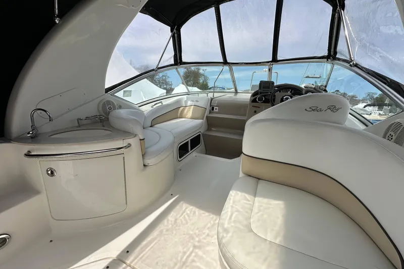 Slide: The Image of 2008 Sea Ray Sundancer 260 interior with white seating and helm, showcasing luxury design. - 14