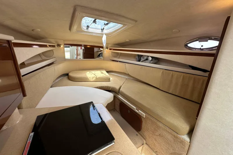 Slide: The Image of Interior cabin of 2008 Sea Ray Sundancer 260, featuring cozy seating and natural light. - 16