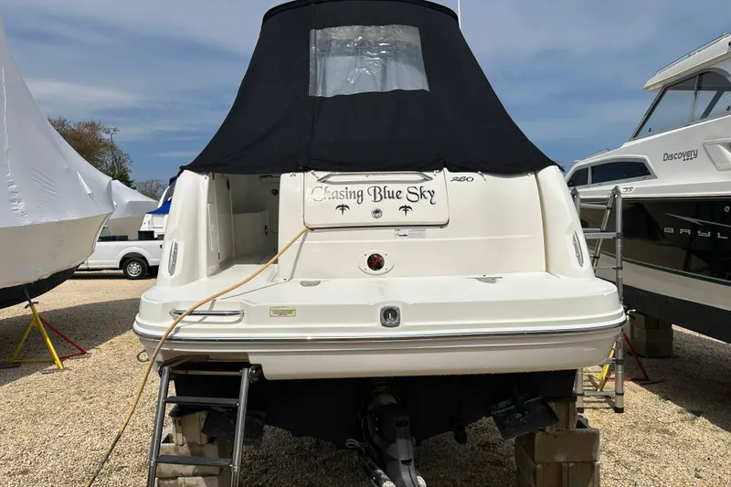 Slide: The Image of 2008 Sea Ray Sundancer 260 boat named "Chasing Blue Sky" on dry dock with cover. - 22