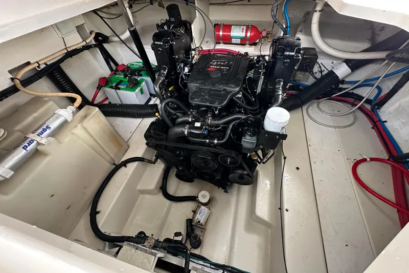 Slide: The Image of Engine compartment of a 2008 Sea Ray Sundancer 260, featuring a well-maintained motor and components. - 9