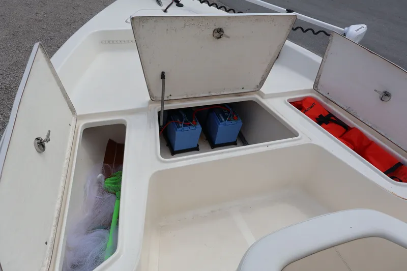 Slide: The Image of Bulls Bay 2000 boat 2023 with open storage compartments and batteries. - 21