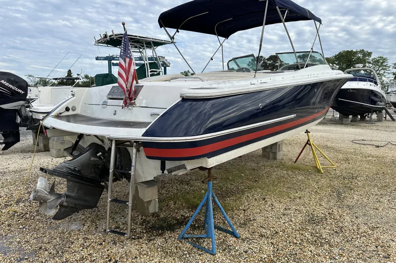 Slide: The Image of 2005 Chris-Craft Launch 28 boat on stands, with American flag, in a marina setting. - 12