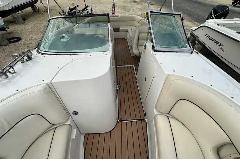 Slide: The Image of 2005 Chris-Craft Launch 28 boat interior with teak flooring and white seating. - 15