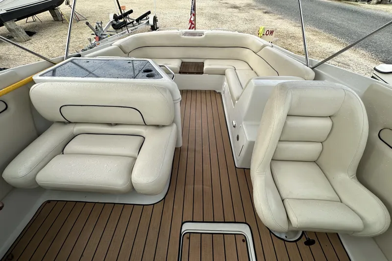 Slide: The Image of 2005 Chris-Craft Launch 28 boat interior with white leather seating and teak flooring. - 16