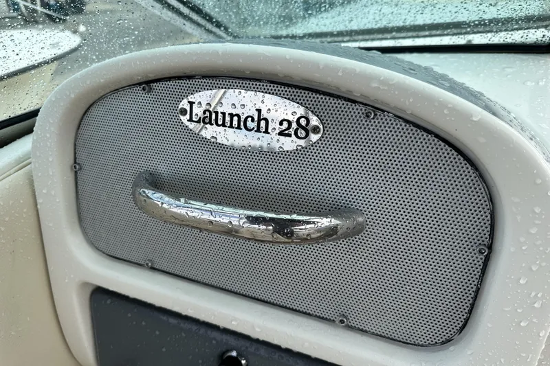 Slide: The Image of 2005 Chris-Craft Launch 28 dashboard with raindrops on metallic surface. - 18