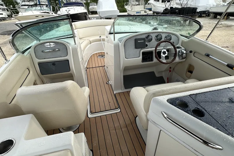 Slide: The Image of 2005 Chris-Craft Launch 28 boat interior with wooden deck and steering console. - 19