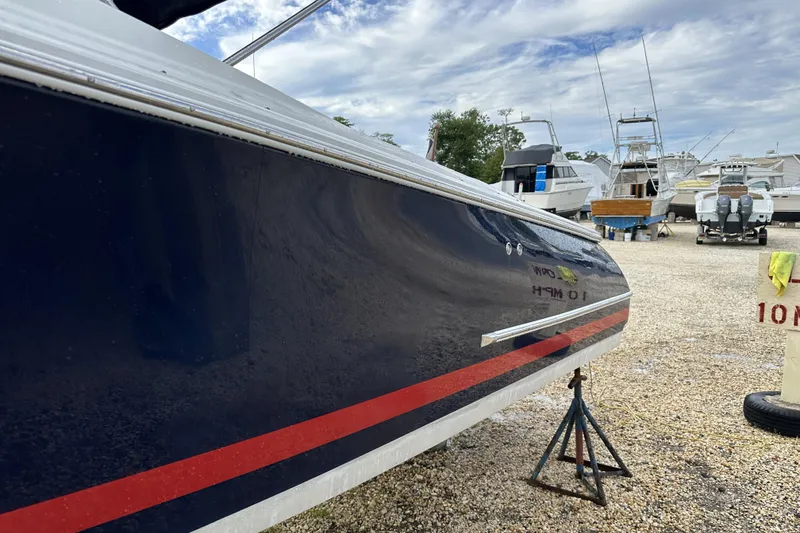 Slide: The Image of 2005 Chris-Craft Launch 28 boat on stands in a marina, side view. - 3