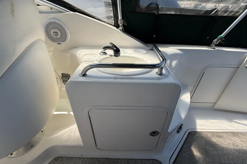Slide: The Image of Interior of 2002 Sea Ray Sundancer 260 boat featuring a compact sink area. - 11