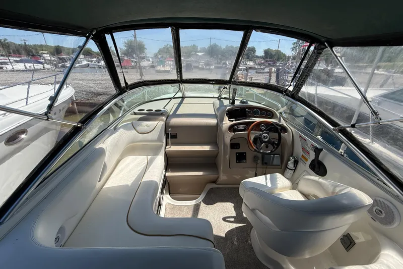 Slide: The Image of Interior view of 2002 Sea Ray Sundancer 260 boat cockpit with steering wheel and seating. - 13