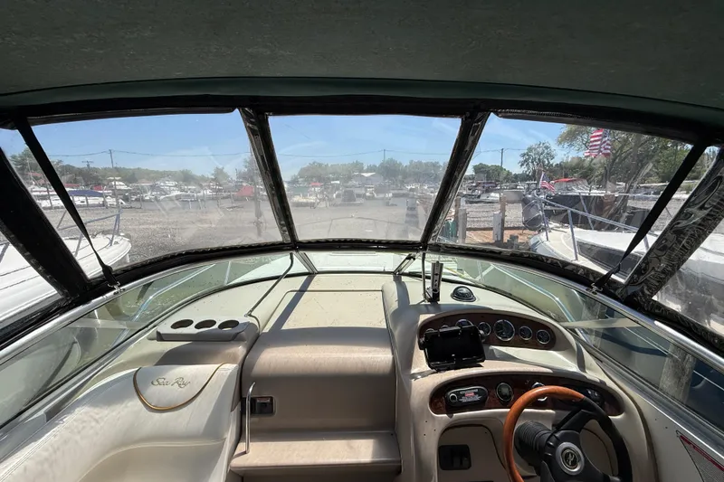 Slide: The Image of Interior view of 2002 Sea Ray Sundancer 260 boat cockpit with steering wheel and dashboard. - 17