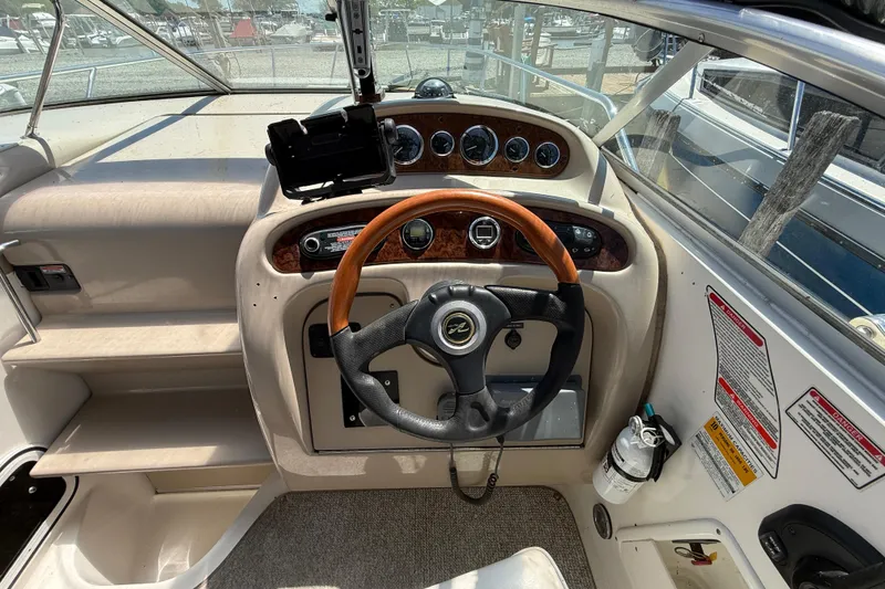 Slide: The Image of Cockpit of 2002 Sea Ray Sundancer 260 with steering wheel and instrument panel. - 18