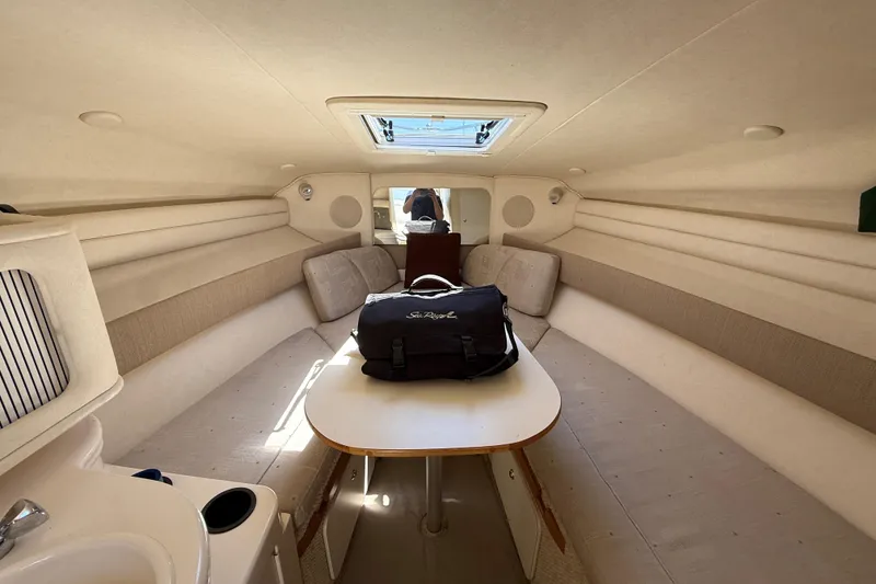 Slide: The Image of Interior of 2002 Sea Ray Sundancer 260 cabin with seating and table. - 22