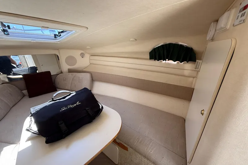Slide: The Image of Interior of 2002 Sea Ray Sundancer 260 cabin with seating and a Sea Ray bag. - 23