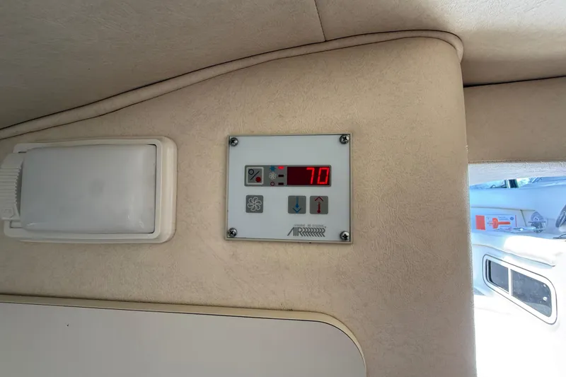 Slide: The Image of Control panel inside 2002 Sea Ray Sundancer 260 boat, displaying temperature at 70 degrees. - 24