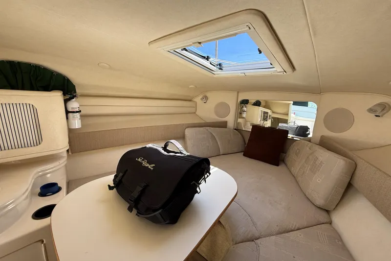 Slide: The Image of Interior of 2002 Sea Ray Sundancer 260 with seating, table, and skylight. - 25