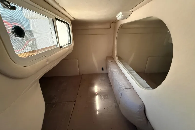 Slide: The Image of Interior cabin of a 2002 Sea Ray Sundancer 260 boat, featuring a cozy seating area. - 35