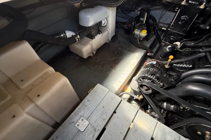 Slide: The Image of Engine compartment of a 2002 Sea Ray Sundancer 260 boat, showing mechanical components. - 38