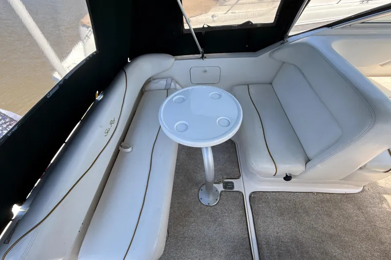 Slide: The Image of Interior seating area of a 2002 Sea Ray Sundancer 260 boat with a small table. - 5