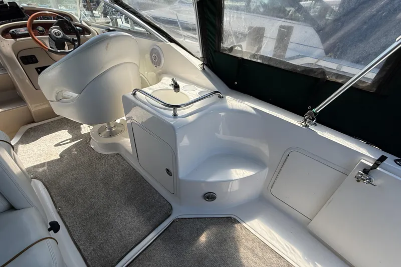 Slide: The Image of Interior of a 2002 Sea Ray Sundancer 260 boat, featuring helm and seating area. - 9