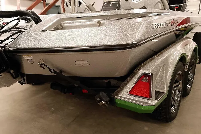 Slide: The Image of 2025 Ranger Z520R boat rear view in a showroom, showcasing sleek design and dual axle trailer. - 13