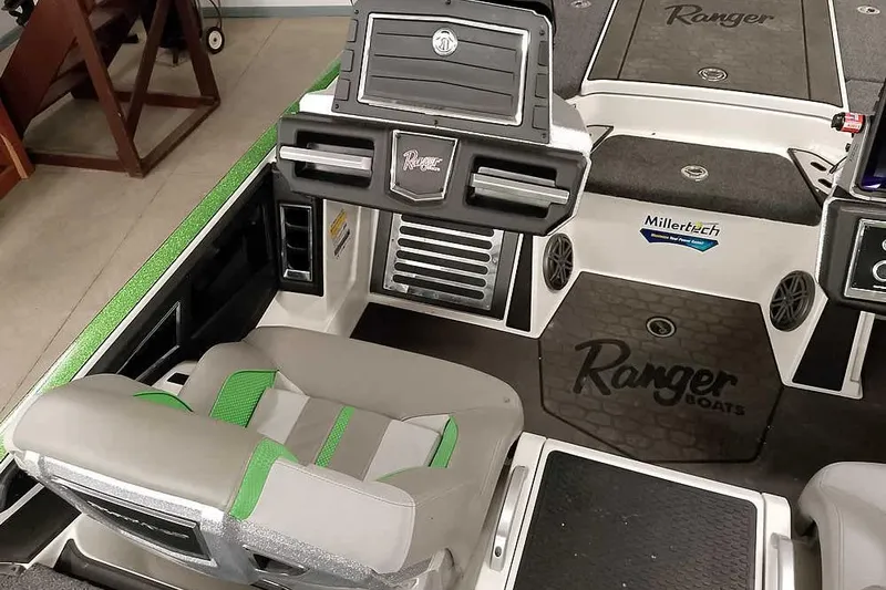 Slide: The Image of 2025 Ranger Z520R boat interior with green accents and advanced dashboard features. - 29