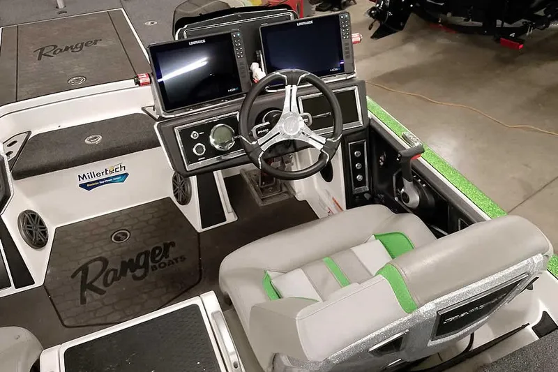 Slide: The Image of 2025 Ranger Z520R boat cockpit with dual screens and modern steering wheel. - 32