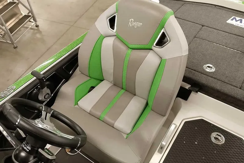 Slide: The Image of 2025 Ranger Z520R boat seat with green and gray accents, steering wheel visible. - 33