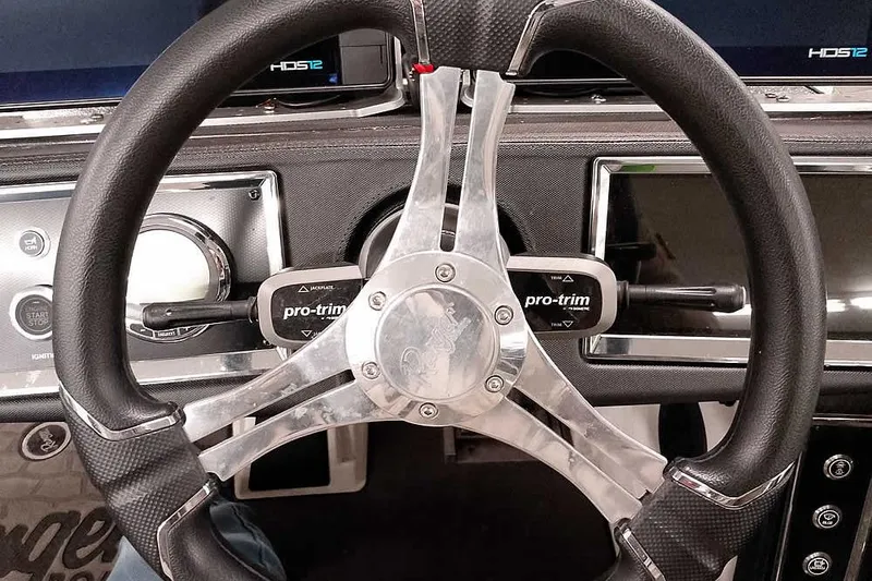 Slide: The Image of Steering wheel of 2025 Ranger Z520R boat with pro-trim controls and dashboard. - 34