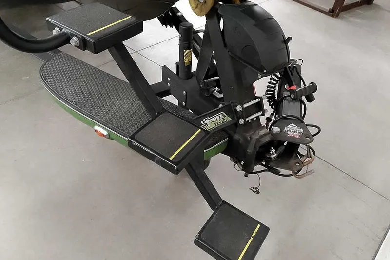 Slide: The Image of 2025 Ranger Z520R boat trailer with step system and winch, displayed indoors. - 4