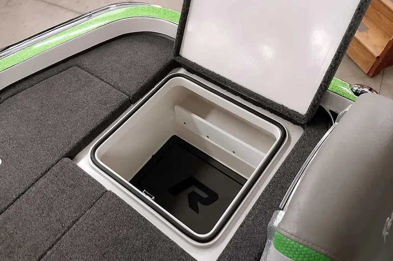 Slide: The Image of Open storage compartment in 2025 Ranger Z520R boat, featuring gray and green interior design. - 40