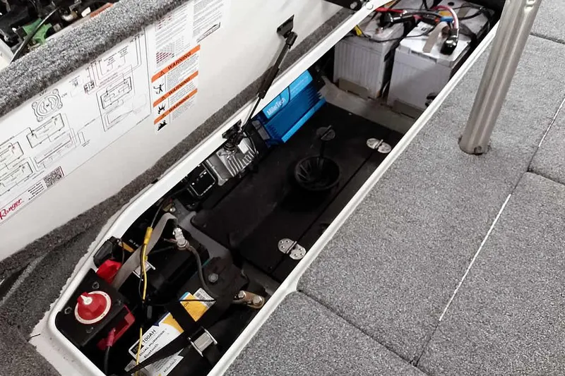 Slide: The Image of 2025 Ranger Z520R boat battery compartment with wiring and safety labels. - 42