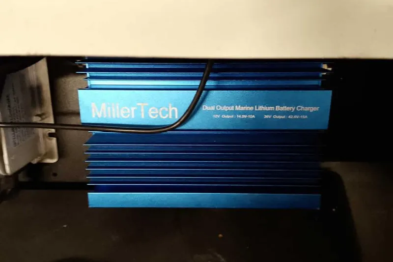 Slide: The Image of Blue MillerTech dual output marine lithium battery charger in a Ranger Z520R, 2025 model. - 43