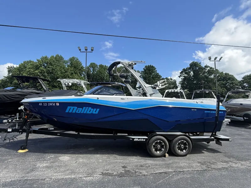 The Image of 2022 Malibu Wakesetter 25 LSV boat on trailer, blue sky. - 1