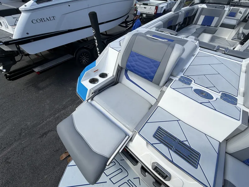 Slide: The Image of 2022 Malibu Wakesetter 25 LSV boat interior with blue accents. - 11