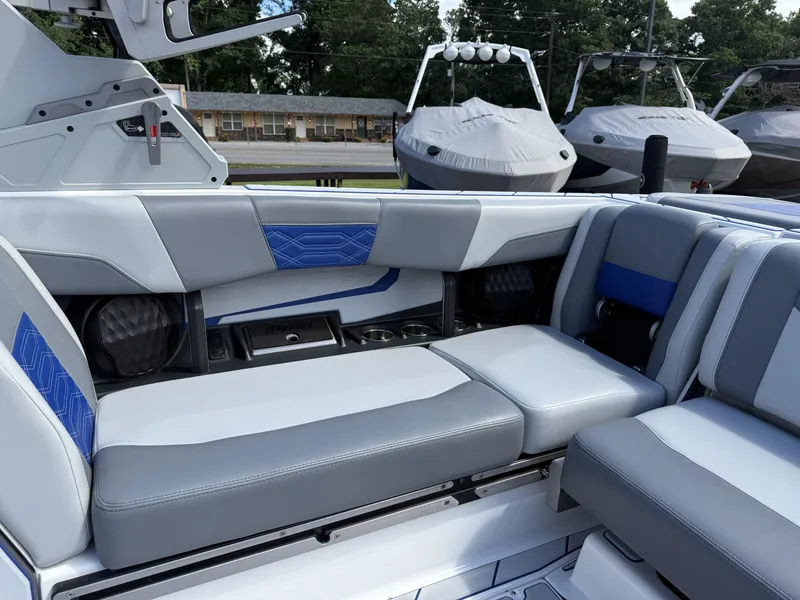 Slide: The Image of Interior of 2022 Malibu Wakesetter 25 LSV with gray and blue seating. - 14