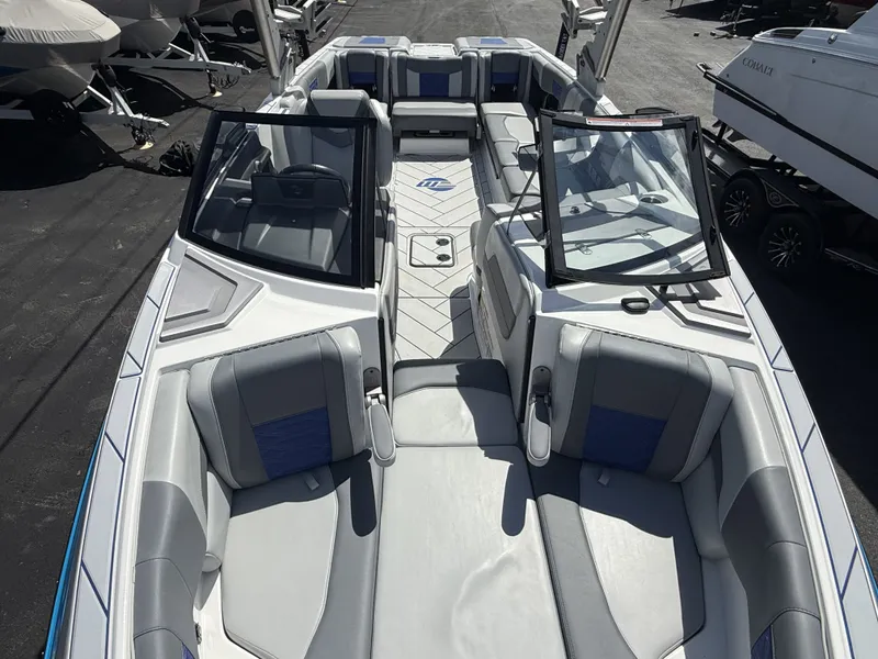 Slide: The Image of 2022 Malibu Wakesetter 25 LSV boat with gray seating and open cockpit. - 25