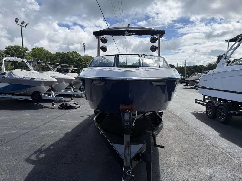 Slide: The Image of 2022 Malibu Wakesetter 25 LSV boat on a trailer outdoors. - 6