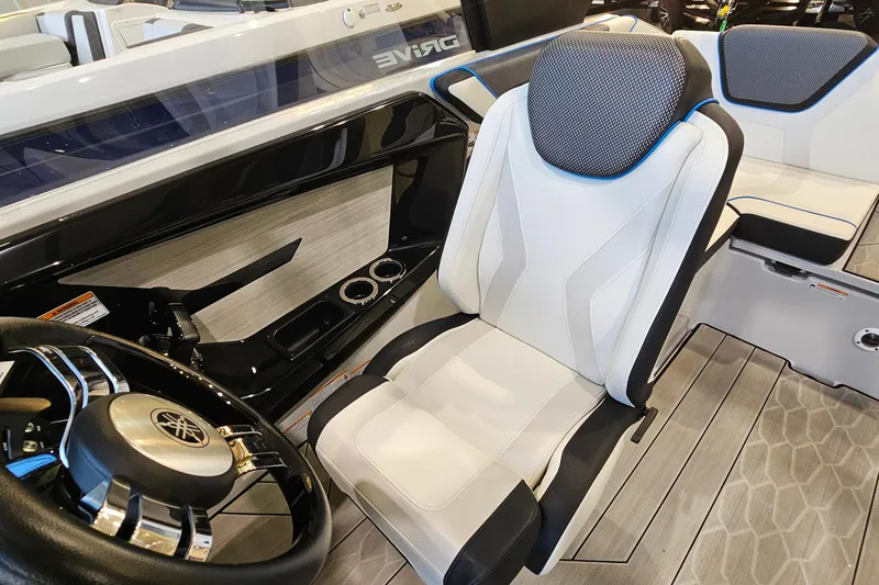 Slide: The Image of 2023 Yamaha Boats 222XD cockpit with sleek steering wheel and modern seating design. - 12