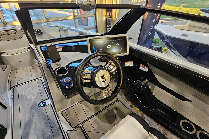 Slide: The Image of 2023 Yamaha Boats 222XD cockpit with modern steering and touchscreen display. - 13
