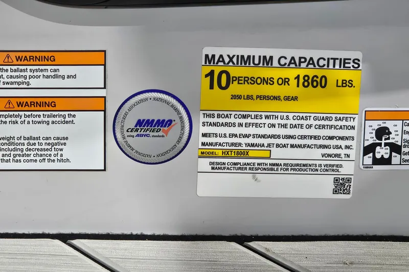 Slide: The Image of 2023 Yamaha Boats 222XD capacity label, warning signs, and NMMA certification displayed. - 23