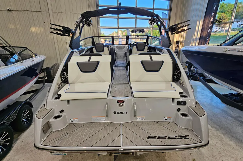 Slide: The Image of 2023 Yamaha Boats 222XD in showroom, showcasing sleek design and spacious seating. - 6