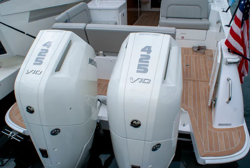Slide: The Image of Two Mercury 425 V10 engines on a 2027 MJM Yachts 38R, featuring teak decking and an American flag. - 46