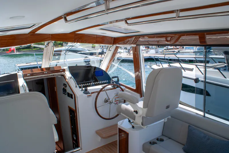 Slide: The Image of The image shows the cockpit of a 2027 MJM Yachts 38R with elegant wood accents. - 21
