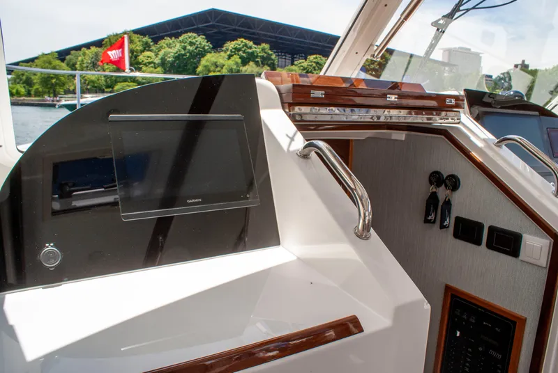 Slide: The Image of The cockpit of the 2027 MJM Yachts 38R features a modern navigation system and controls. - 33