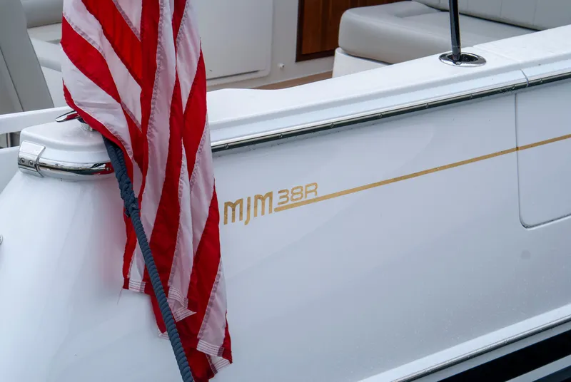 Slide: The Image of The 2027 MJM 38R features a sleek white surface with an American flag motif. - 44