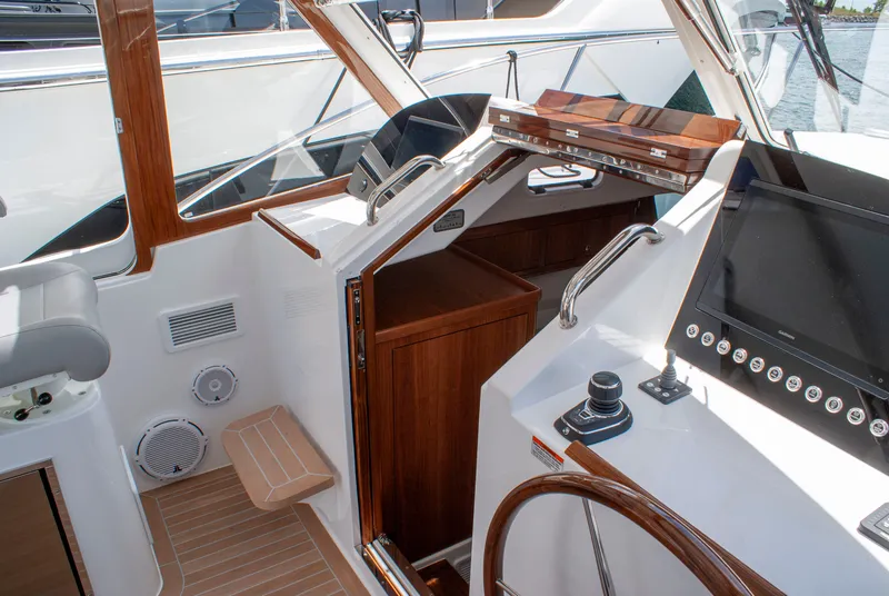 Slide: The Image of The cockpit of a 2027 MJM Yachts 38R with wood paneling and modern instruments. - 26