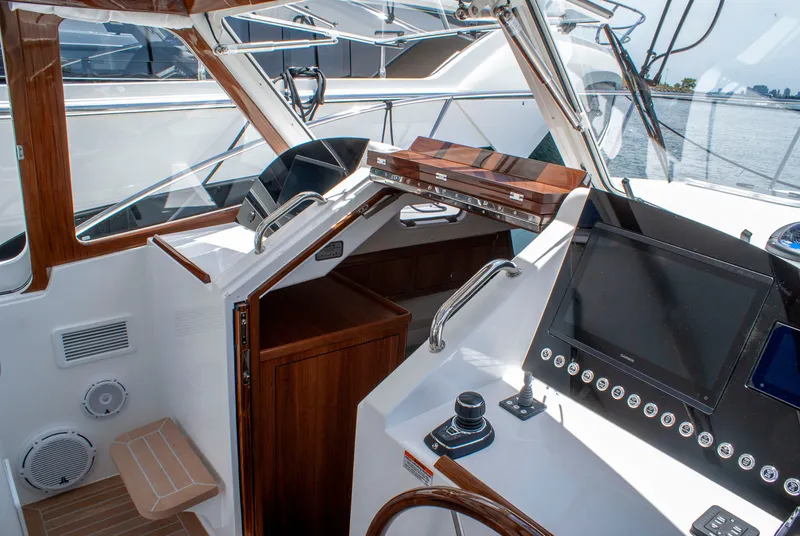 Slide: The Image of The cockpit of the 2027 MJM Yachts 38R features a modern helm with wood accents. - 24