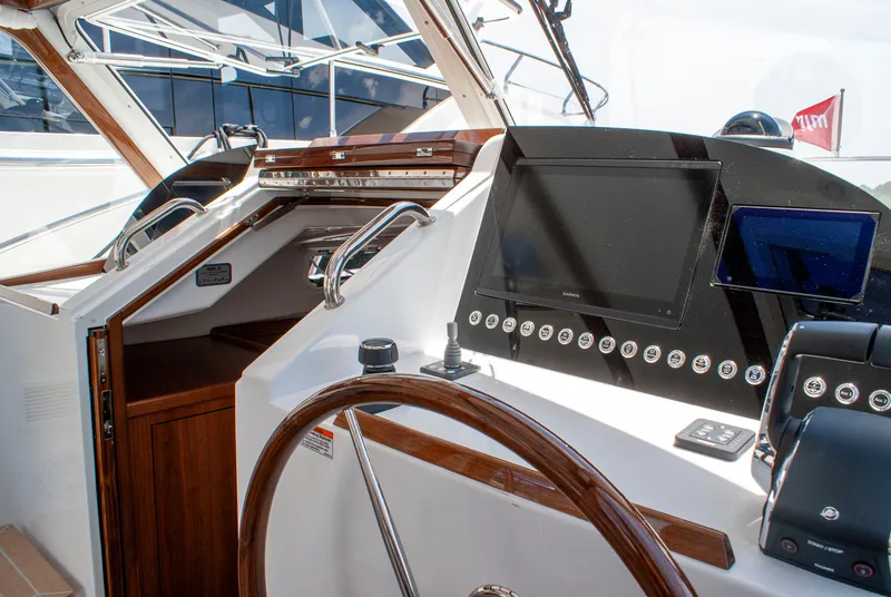 Slide: The Image of The cockpit of the 2027 MJM Yachts 38R features a sleek steering wheel and modern instruments. - 32
